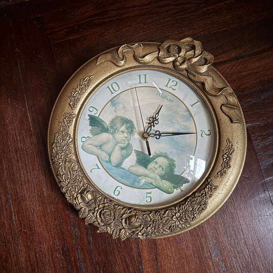ornate framed cherub clock