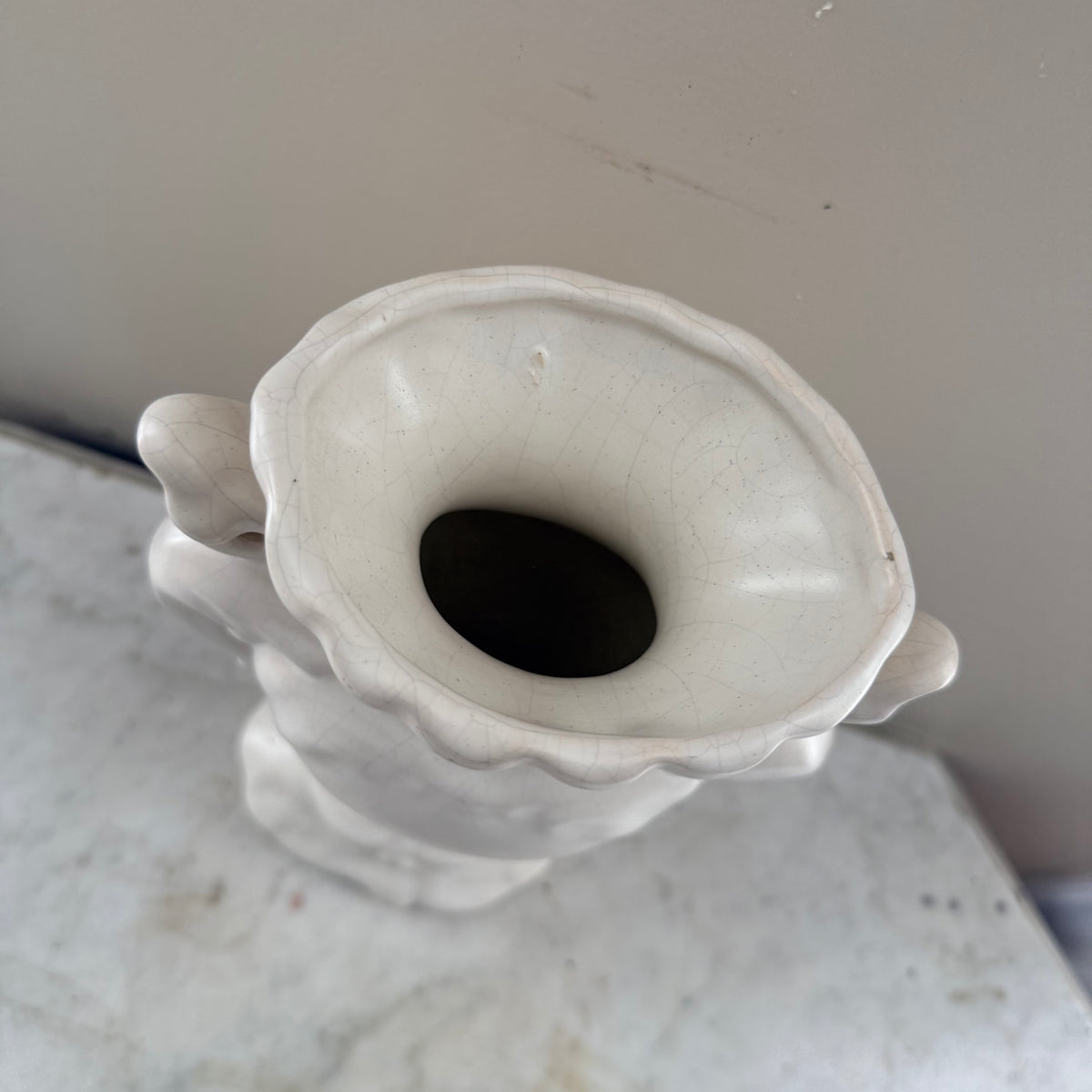 white vase with peacock feathers