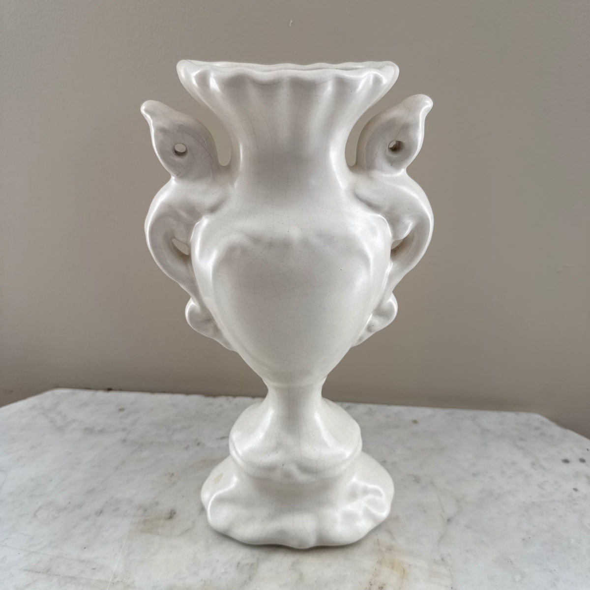 white vase with peacock feathers
