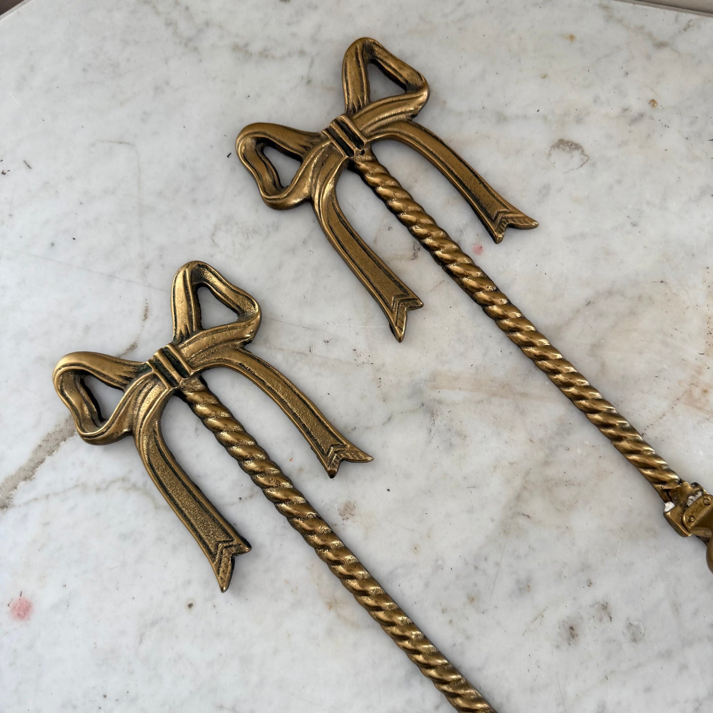 pair of brass bow vase holders