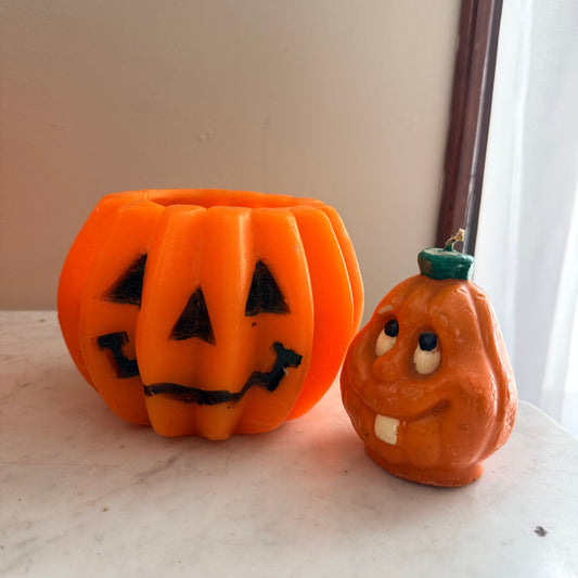 pair of vintage pumpkin candles