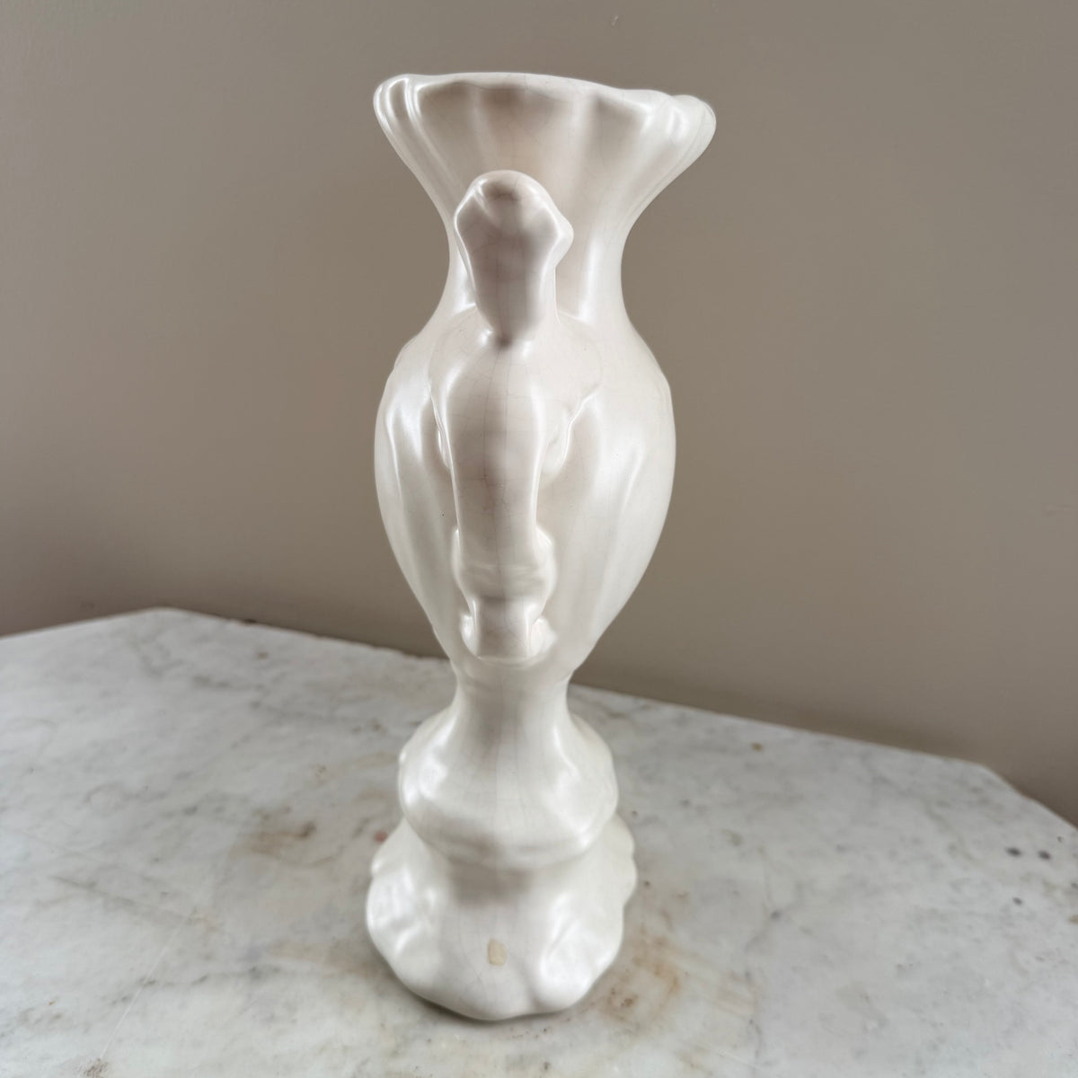 white vase with peacock feathers